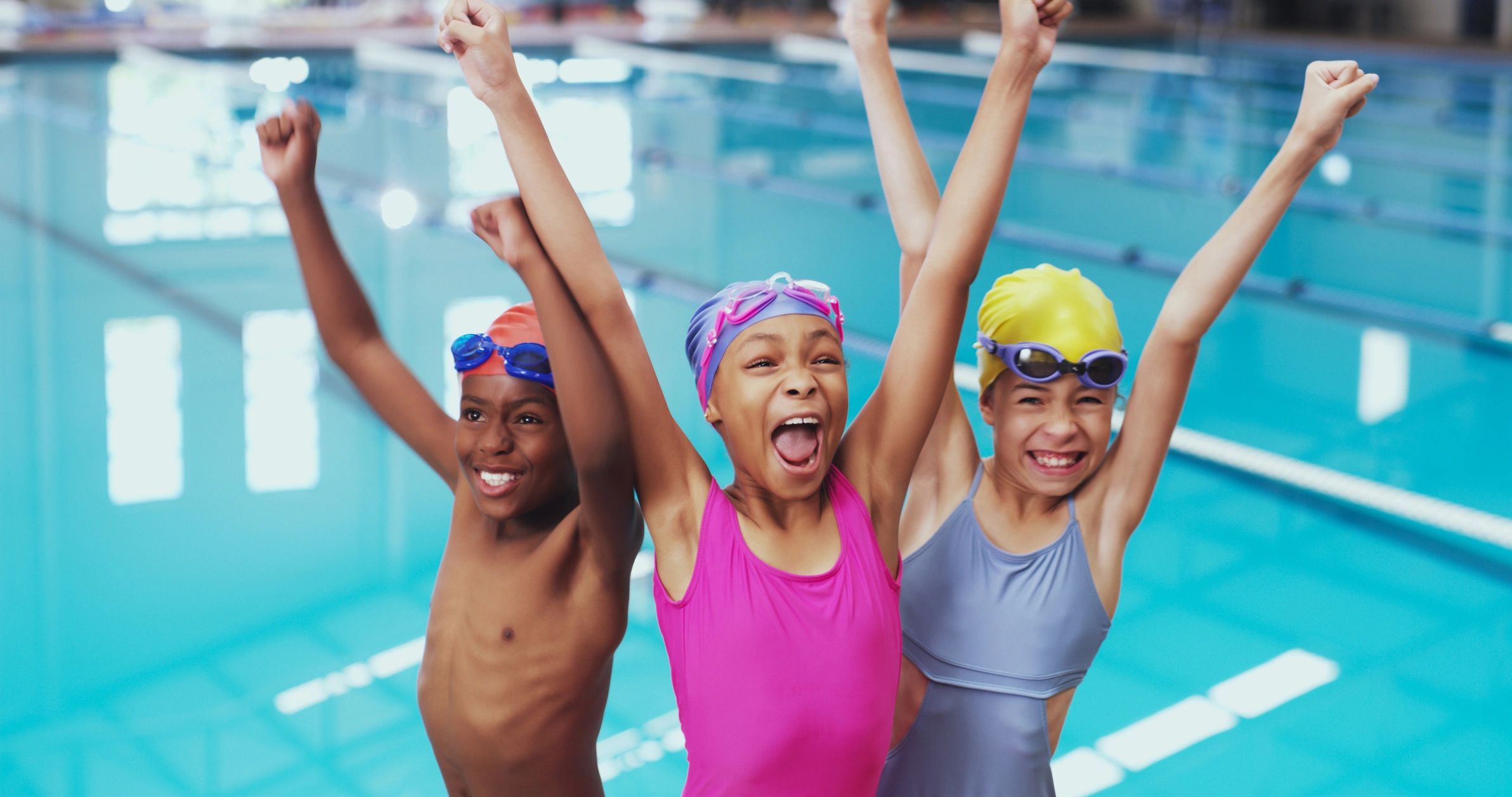 Diverse youth swimming team celebrating success